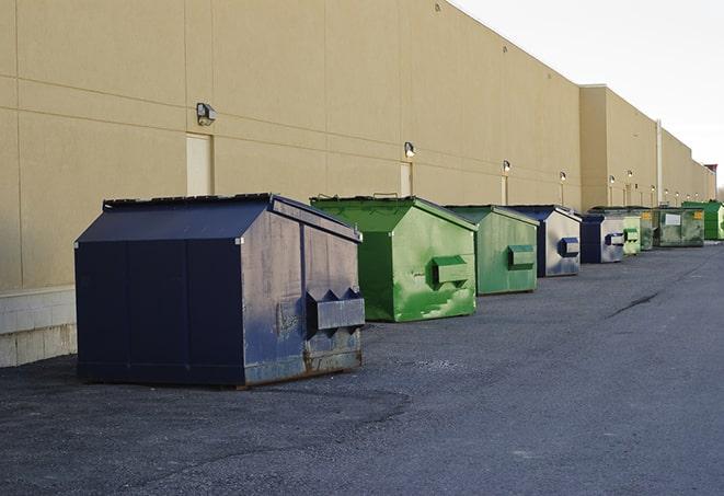 a row of industrial dumpsters for construction waste in Avenal, CA